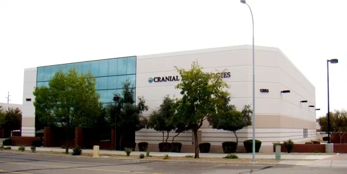 A large building with trees in front of it.