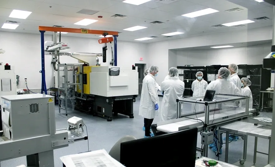 A group of people in lab coats and white hats.