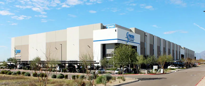 A large building with cars parked in front of it.