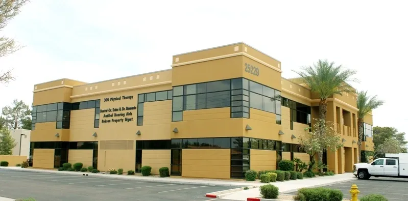 A large building with many windows and doors.