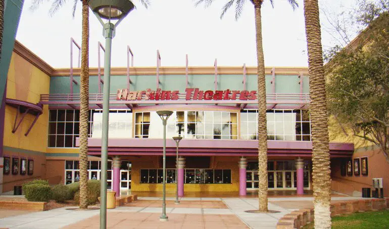 A large building with palm trees in front of it.