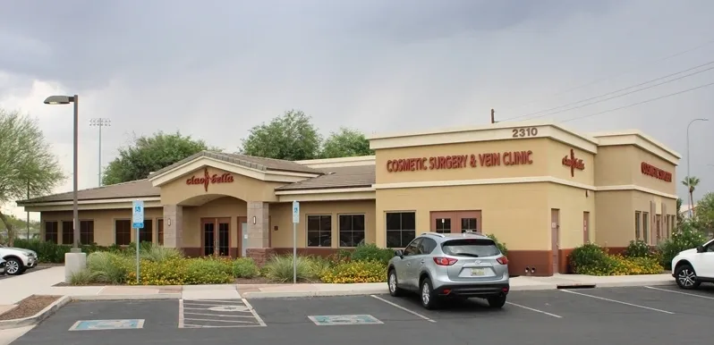 A car parked in front of a building with a sign on it.